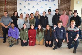 Group of students signing certificate of intent with future employers.