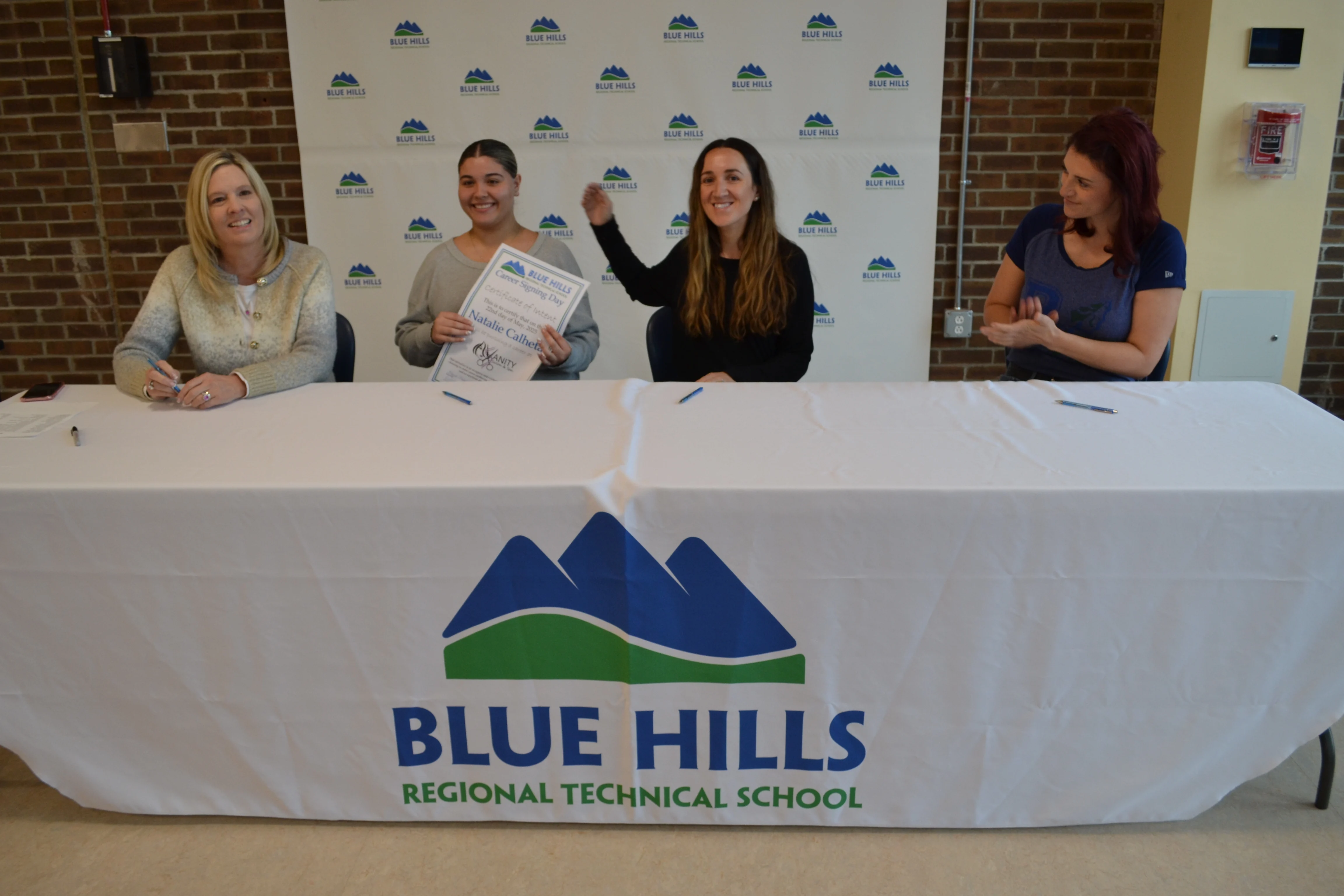 Natalie Calheta posing with certificate of intent to work.