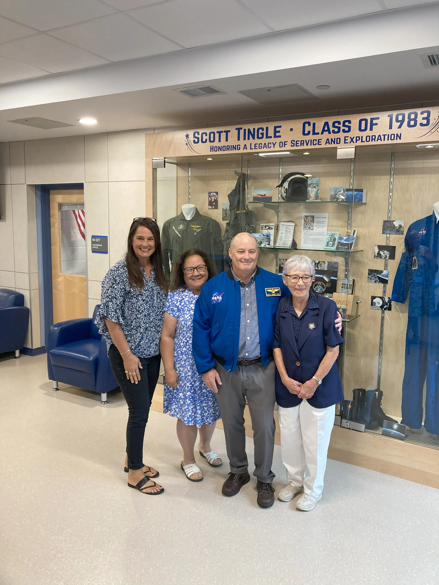 The display case features a collection of photographs from Scott Tingle’s time working on the International Space Station.